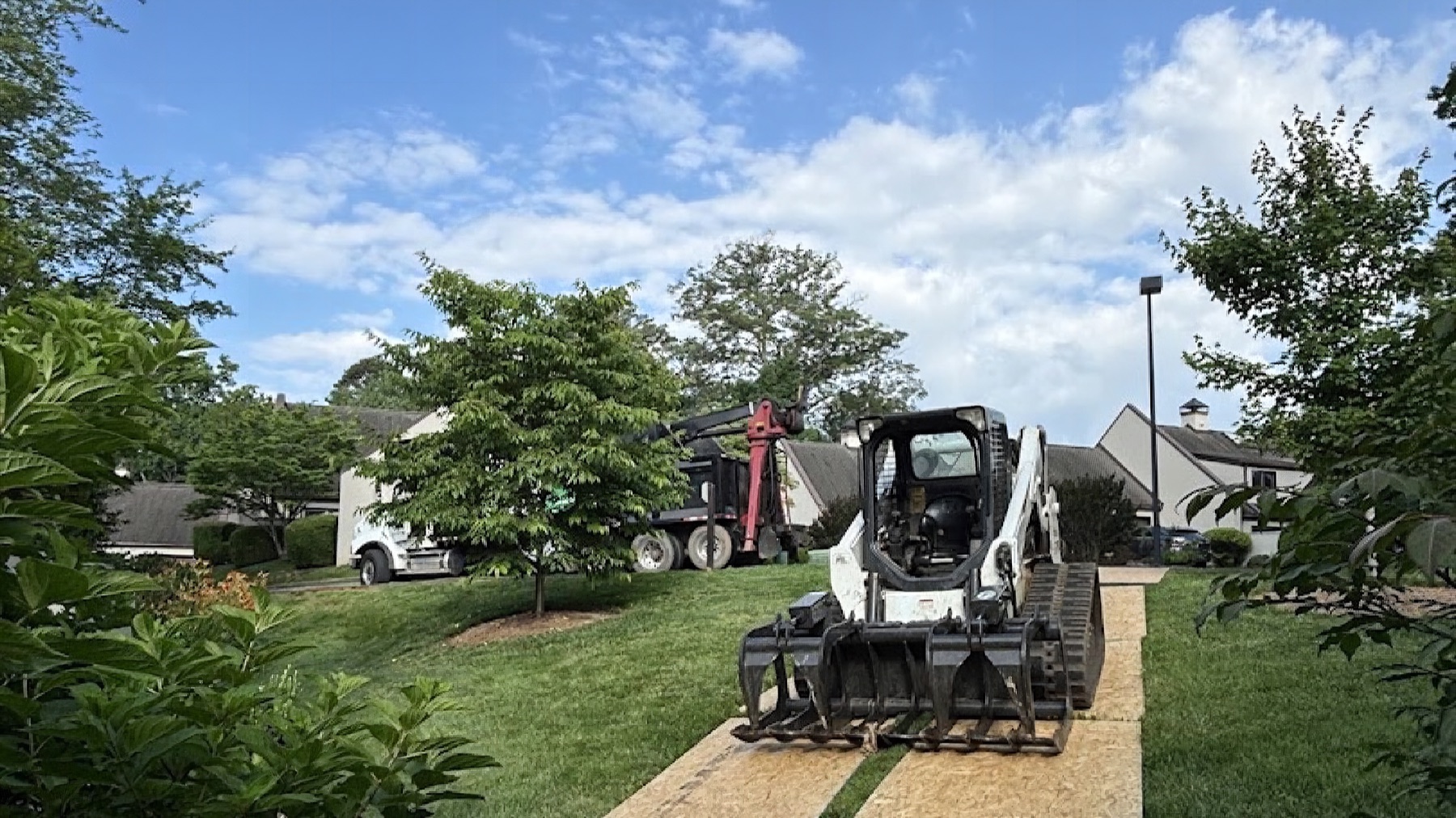 A GTZ Tree Service skid steer clearing a Knoxville yard
