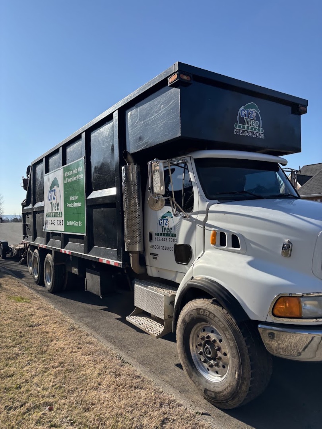 The branded GTZ Tree Service dump truck on a Knoxville job